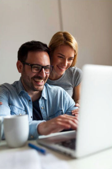 Happy couple using a laptop